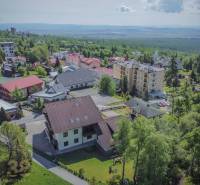 Aerial view of holiday apartments in the High Tatras surrounded by nature and greenery.