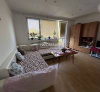 Living room in a 3-room apartment with a sofa, table, cabinet, and television.