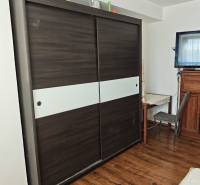 A wardrobe with sliding doors and a writing desk in a 2-room apartment.