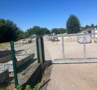 Commercial land on Popradská Street in Bratislava - Podunajské Biskupice, fenced area with a gate.