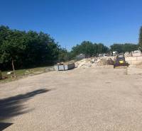 A construction site with containers and construction waste on commercial land on Popradská in Bratislava - Podunajské Biskupice.