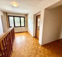 Hallway with parquet flooring and glass doors in a family house.