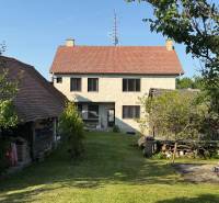 A family house in Koválov with a garden, trees, and a spacious green plot.