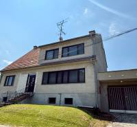 A family house in Koválov with bright windows and a garage on a gently sloping plot.