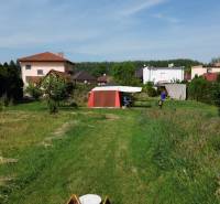 A garden with a lawn in Dolný Bar, with a view of houses and a tent. Plots - housing.