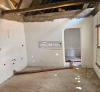 The interior of a family house with an empty room, exposed ceiling beams.