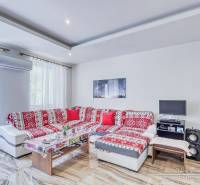 Living room with a red sofa and a table, 2-room apartment, air conditioning.