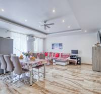 Spacious living area with dining table and sofa in a 2-room apartment.
