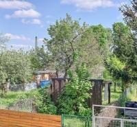 A garden with a wooden shelter surrounded by greenery on Staničná Street in Trnava.