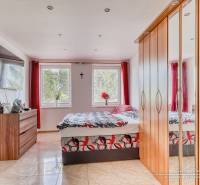 Bedroom with a large wardrobe and television in a 2-room apartment.