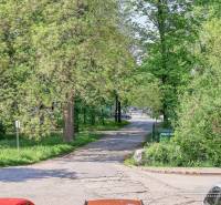 Station Street in Trnava, lined with trees, depicts a peaceful urban scene.