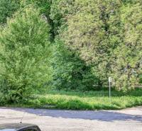 Greenery and parking lot on Staničná Street in Trnava, view from a 2-room apartment.