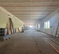 Interior of a warehouse hall with ladders and building materials, warehouses and halls suitable for work.