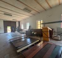 Interiors of warehouses and halls with sheet metal materials and a wide gate for light.