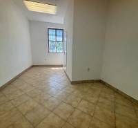 A room with tiles and a large window, suitable for use in warehouses and halls.
