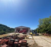 Warehouses and halls in Mníchova Lehota with a hall, a red car, and a forklift.