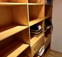 Storage space with wooden shelves and drawers in a 2-room apartment.