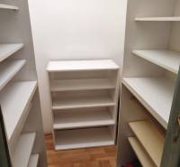 Storage space with a white shelving system in a 2-room apartment.