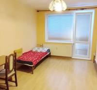 A room in a 2-room apartment with a bed, a table, a television, and a wardrobe.