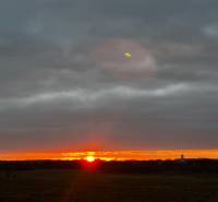 Sunset in Bratislava - Devínska Nová Ves with wind turbines on the horizon.