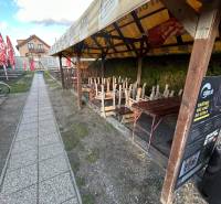 Covered terrace of a gastro space with enclosed seating on Devínske jazero street, Bratislava.
