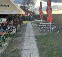Sidewalk next to gastro spaces with bicycles and umbrellas, Devínska Nová Ves, Devínske jazero.