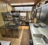 Professional kitchen with stainless steel equipment in catering premises.