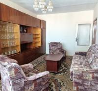 Living room with retro furniture and a carpet in a 2-room apartment.