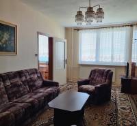 Living room: carpet, sofa set, armchair, painting, chandelier in a 2-room apartment.