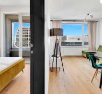 Bright 1-bedroom apartment with a view, comfortable seating, and a double bed in the interior.