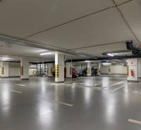 The underground parking on Továrenská Street offers spacious garages with good lighting.