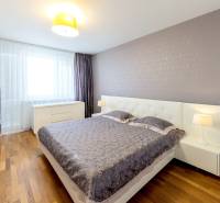 Bedroom in a 3-room apartment with a double bed, nightstands, and wooden flooring.