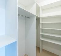 A wardrobe with shelves and a hanging rod in a 3-room apartment.