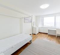 A bright room in a 3-room apartment with a bed and storage space.