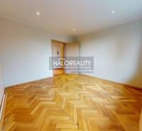 A spacious room with parquet flooring and a window in a 3-room apartment.