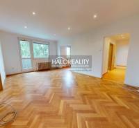 An airy living space with wooden flooring in a 3-room apartment.