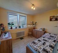 Bedroom in a family house with wooden furniture and houseplants.