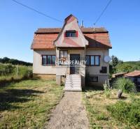 A family house in Topoľčianky with traditional architecture, a garden, and surrounding nature.