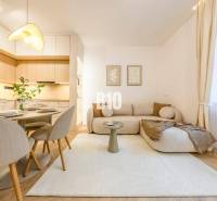 A bright living room on Benediktiho Street in a 3-room apartment, including a kitchen and dining area.