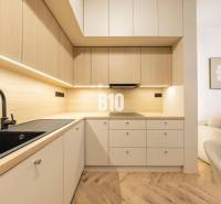 The kitchen on Benediktiho Street in a 3-room apartment, with a minimalist wooden design.