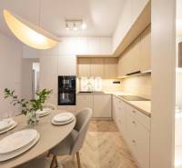 The kitchen in a 3-room apartment on Benediktiho Street, with a table and modern lighting.