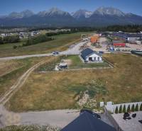 Plots - housing in Mlynica with a view of the High Tatras, surrounding buildings, and nature.