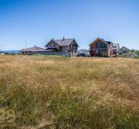 Plots - housing in the village of Mlynica. View of houses and open green area.
