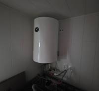 A boiler and pipes in the utility room at the cottage.