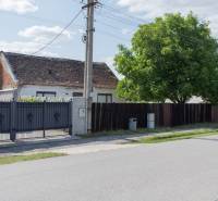 Family house on Športová Street in Gajary, Residential plots with a gate and a tree.