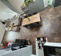 Interior of a family house with a spacious living area, sofa, and dining table.