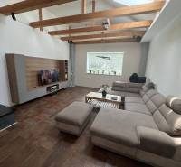 Living room in a family house with a comfortable sofa and wooden beams.