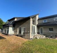 A family house on Hlavná Street in Benkovce with a glass-enclosed terrace and a garden.