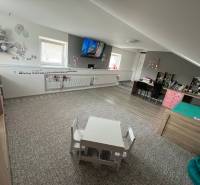 Children's room in a family house with toys, a table, and cozy furniture.
