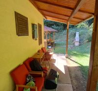 Covered terrace of the cottage on Dobrá Street in Kvakovce with seating and an outdoor fireplace.